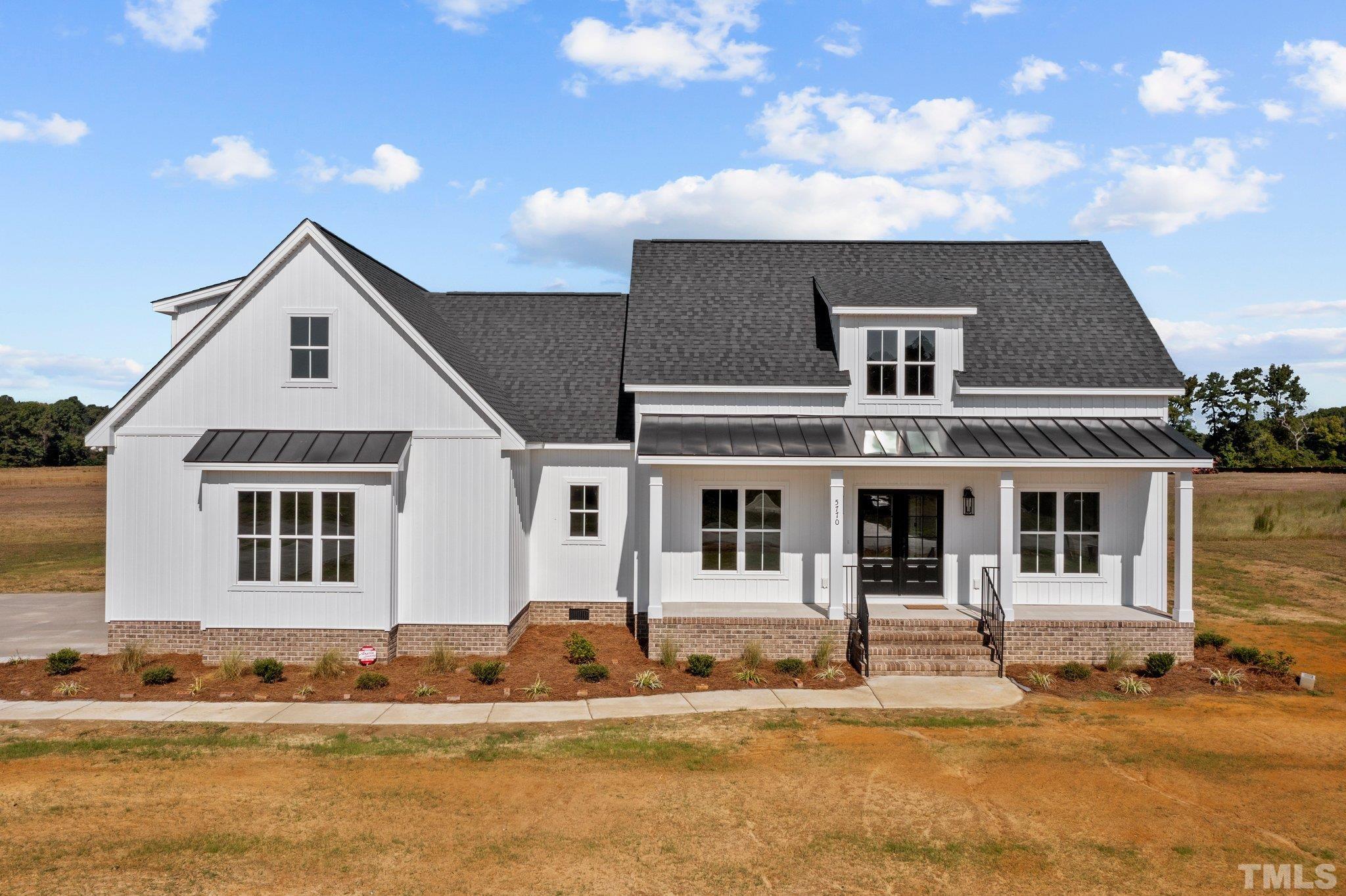 5901 Harvest Rdg Road Battleboro, NC 27809 - Photo 1 of 33 a front view of a house with a ocean view