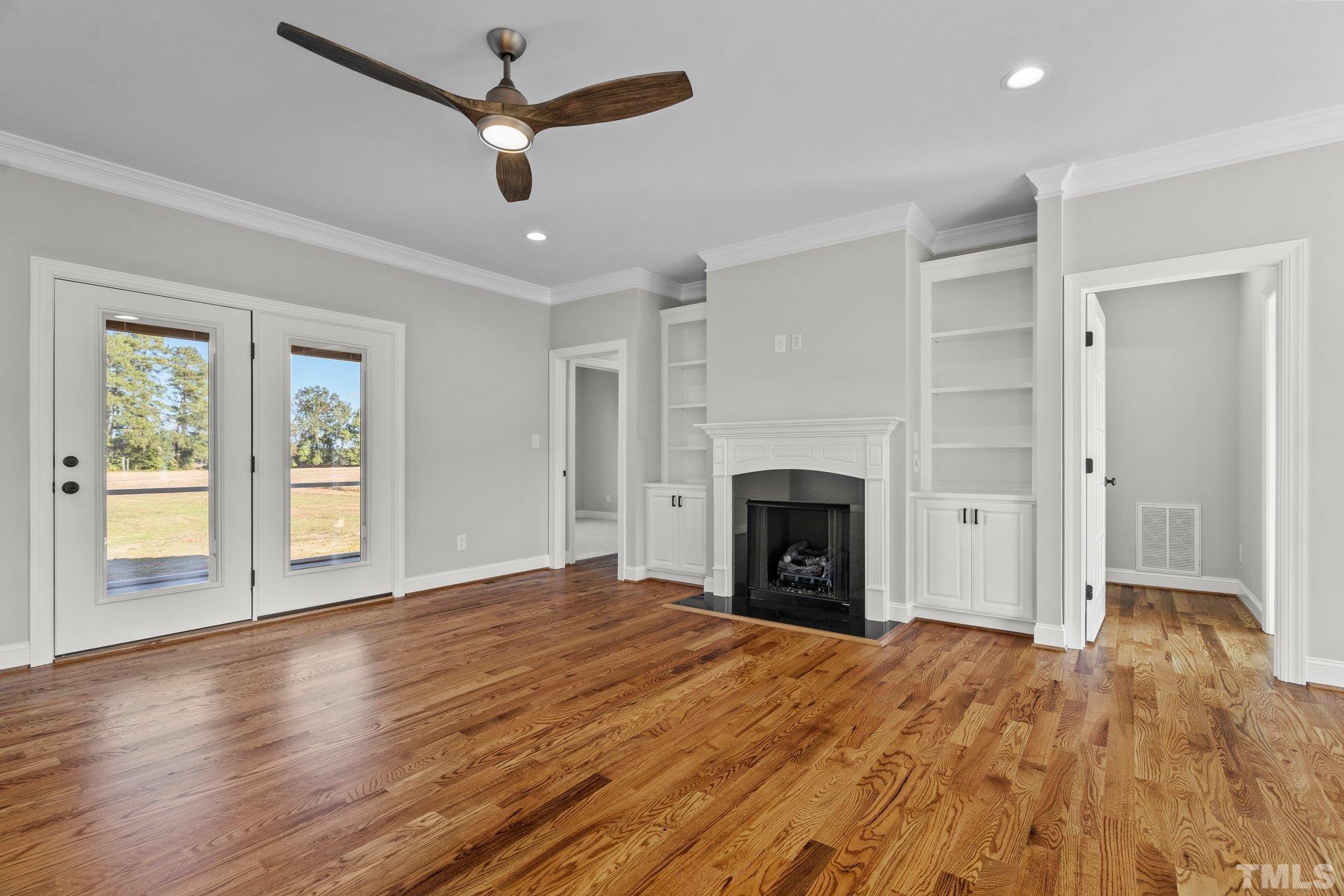5901 Harvest Rdg Road Battleboro, NC 27809 - Photo 13 of 33 a view of empty room with wooden floor and fireplace