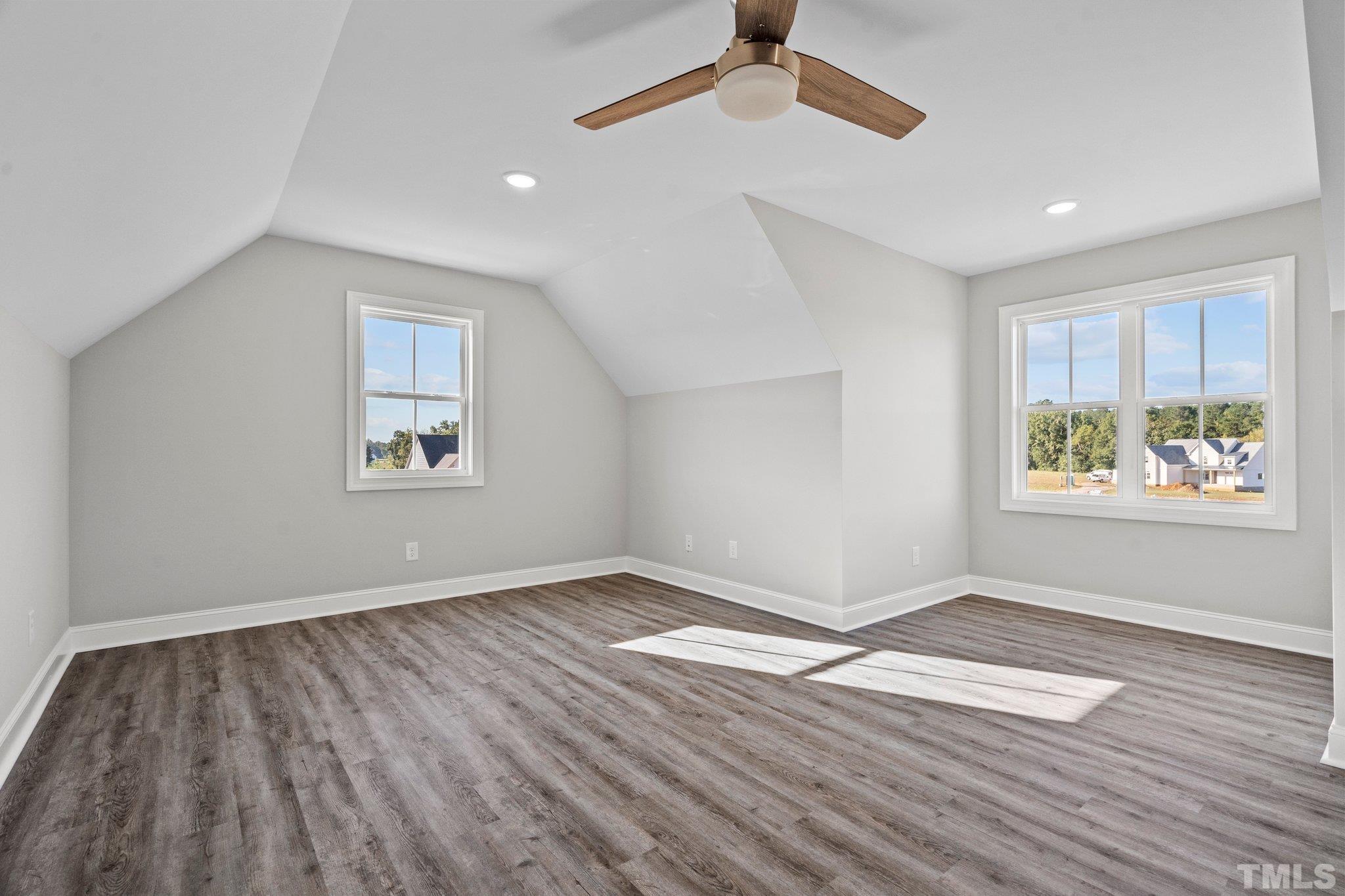 5901 Harvest Rdg Road Battleboro, NC 27809 - Photo 26 of 33 an empty room with wooden floor chandelier fan and windows