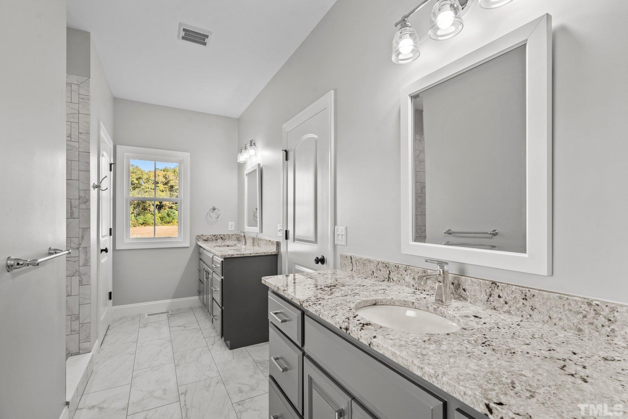 5901 Harvest Rdg Road Battleboro, NC 27809 - Photo 28 of 33 a bathroom with a granite countertop sink mirror and a bathtub