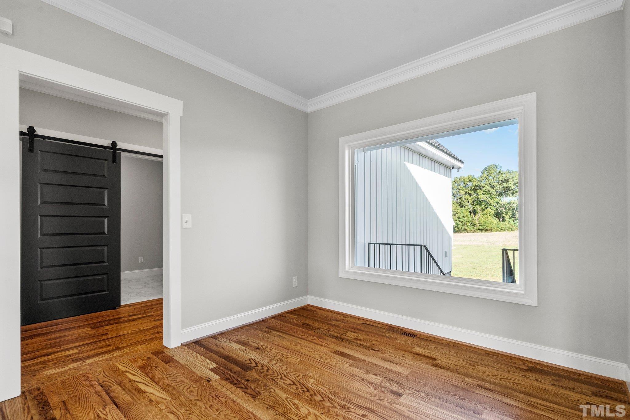 5901 Harvest Rdg Road Battleboro, NC 27809 - Photo 31 of 33 an empty room with wooden floor cabinet and windows