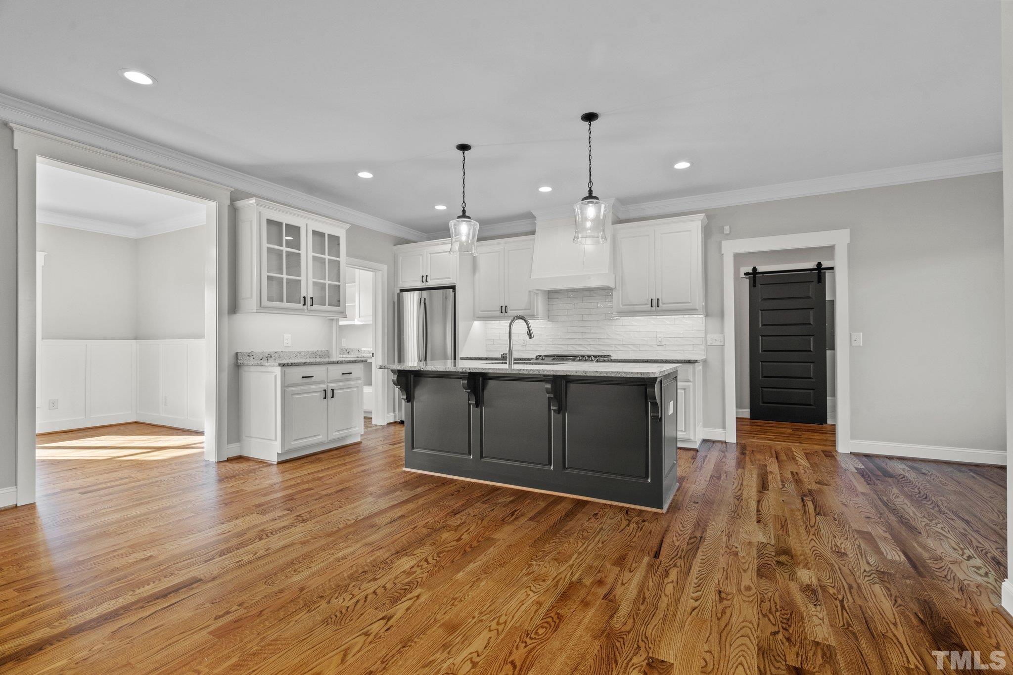 5901 Harvest Rdg Road Battleboro, NC 27809 - Photo 6 of 33 a kitchen with stainless steel appliances granite countertop a stove top oven a sink dishwasher and a refrigerator with wooden floor