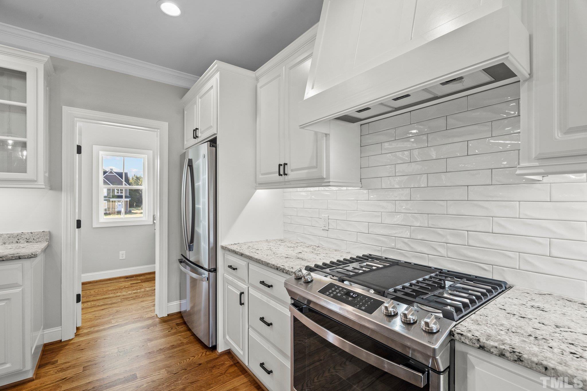 5901 Harvest Rdg Road Battleboro, NC 27809 - Photo 8 of 33 a kitchen with wooden cabinets and a stove top oven