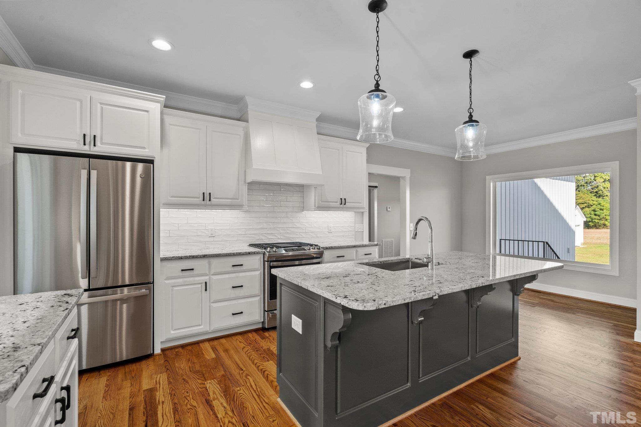 5901 Harvest Rdg Road Battleboro, NC 27809 - Photo 9 of 33 a kitchen with kitchen island granite countertop a sink appliances and cabinets