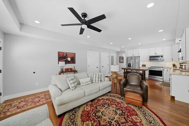 a living room with furniture and kitchen view