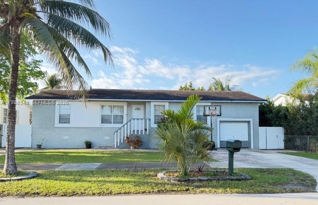 9770 Southwest 210th Street Cutler Bay, FL 33189 - Photo 1 of 32 a front view of house with yard and green space