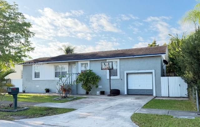 9770 Southwest 210th Street Cutler Bay, FL 33189 - Photo 3 of 32 a front view of a house with a yard and garage