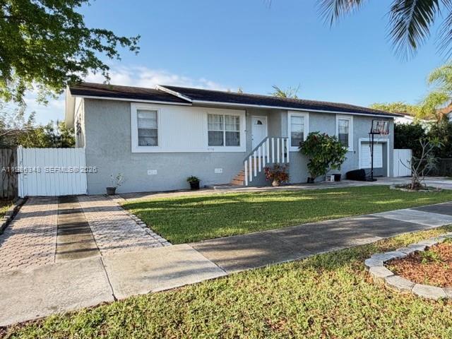 9770 Southwest 210th Street Cutler Bay, FL 33189 - Photo 6 of 32 a front view of a house with a yard