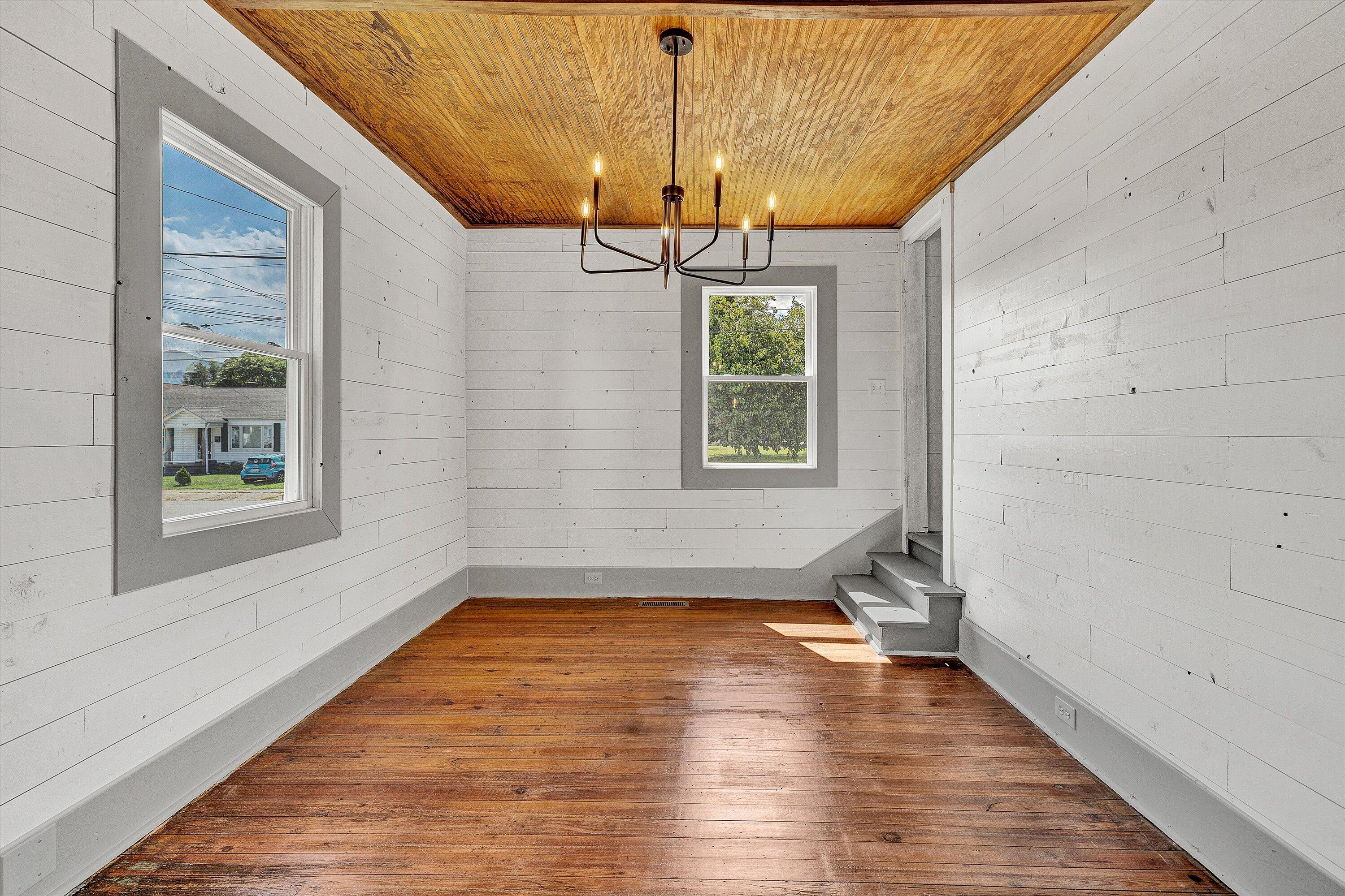 402 7th Street Salem, VA 24153 - Photo 11 of 32 a view of an empty room with a window and wooden floor