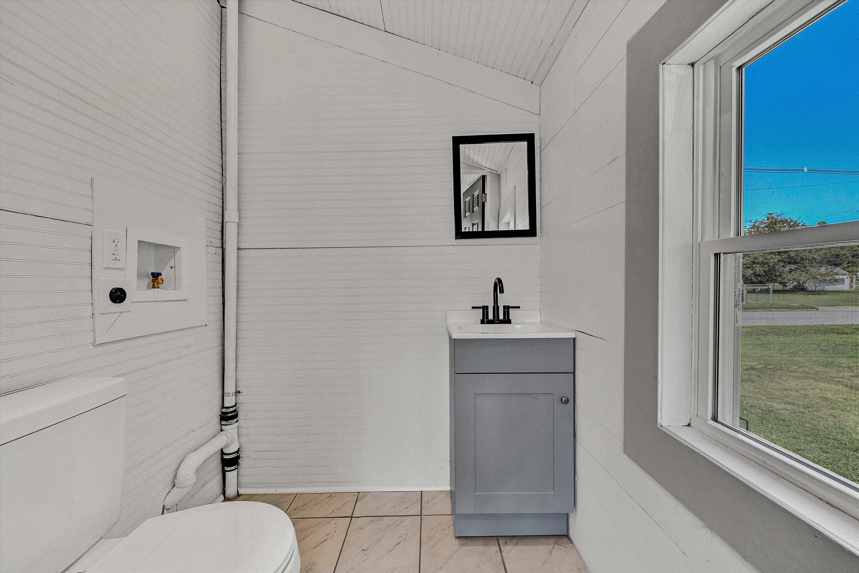 402 7th Street Salem, VA 24153 - Photo 18 of 32 a bathroom with a sink vanity mirror and toilet