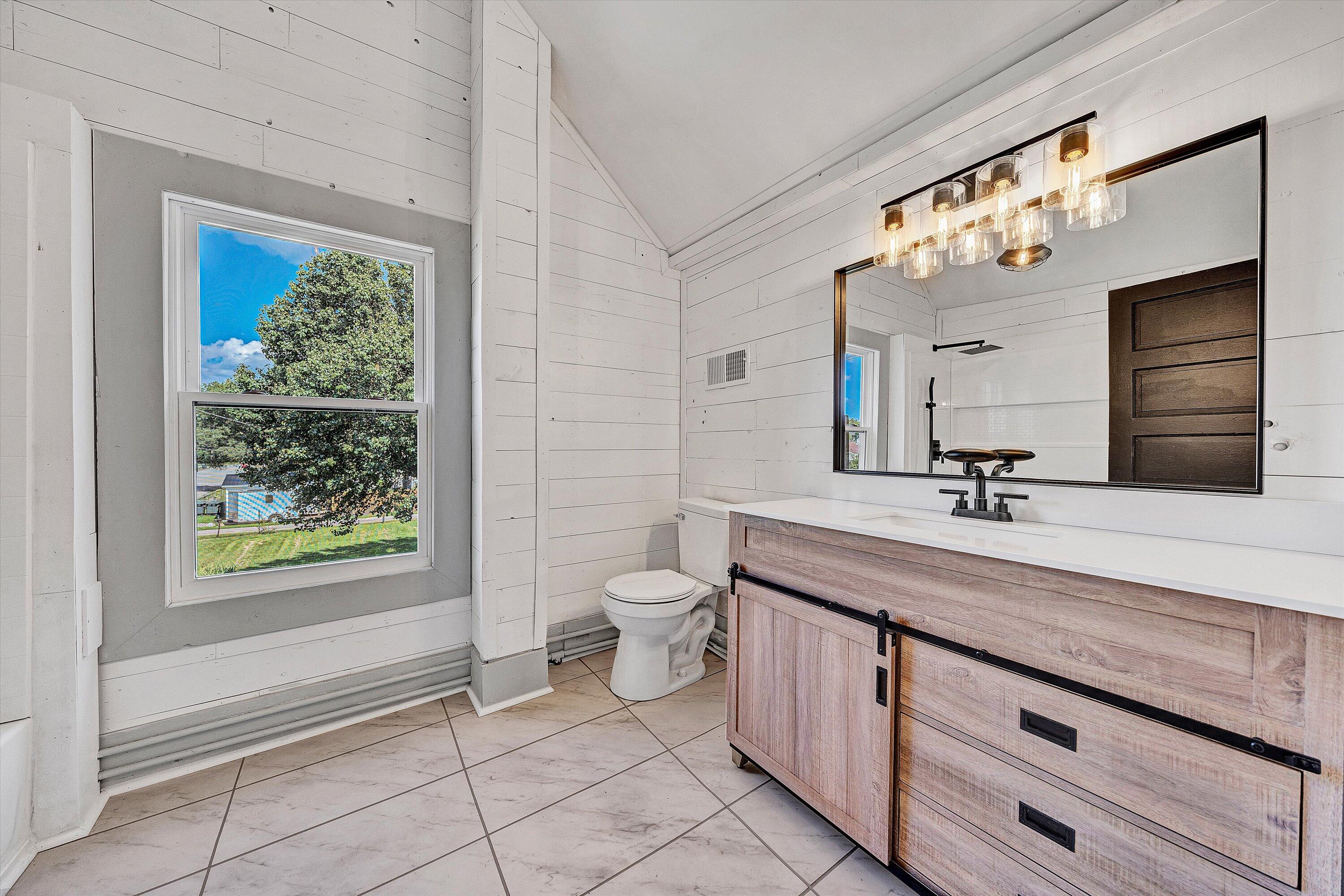 402 7th Street Salem, VA 24153 - Photo 23 of 32 a bathroom with a granite countertop sink a toilet and a mirror