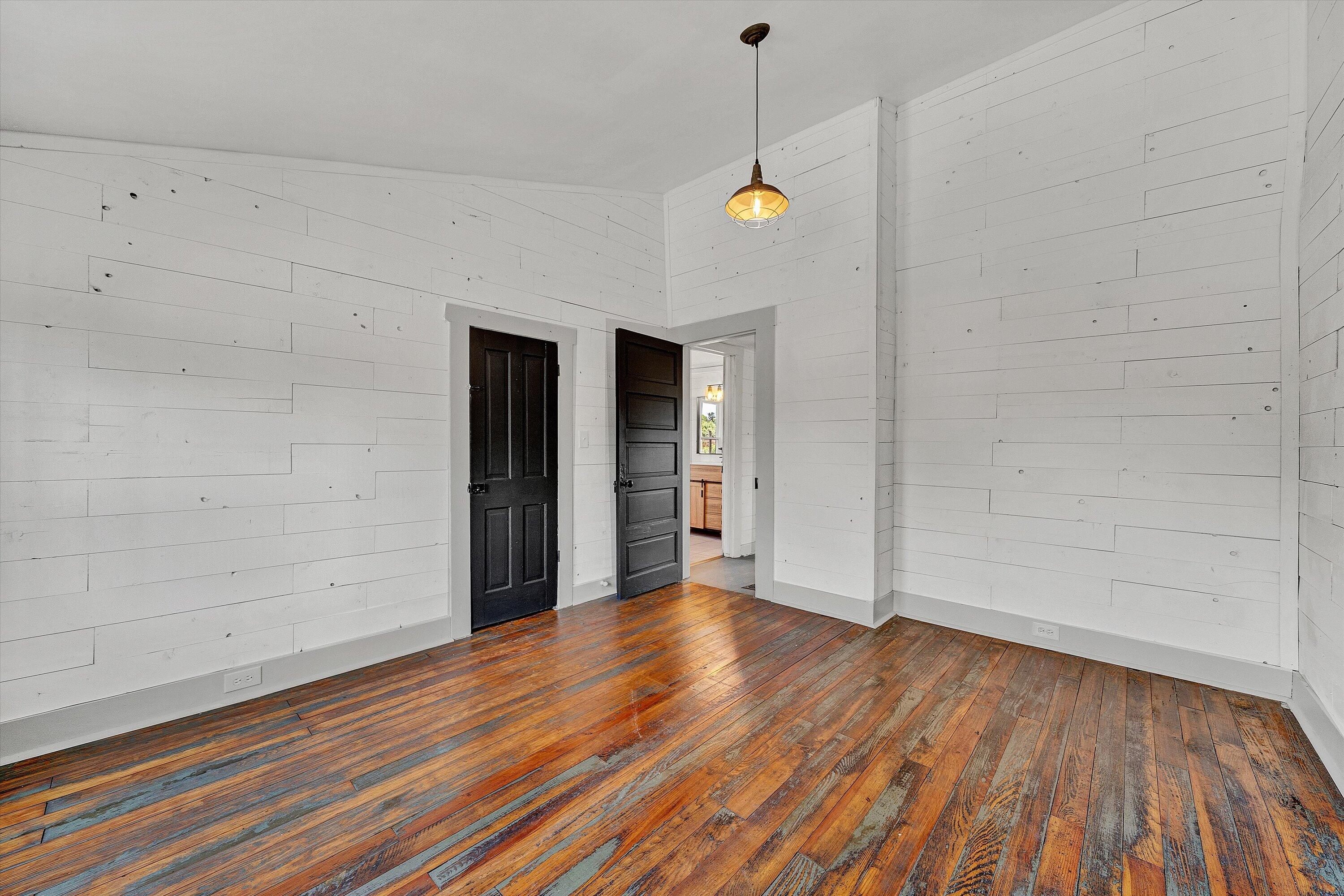402 7th Street Salem, VA 24153 - Photo 26 of 32 a view of an empty room with wooden floor and a window