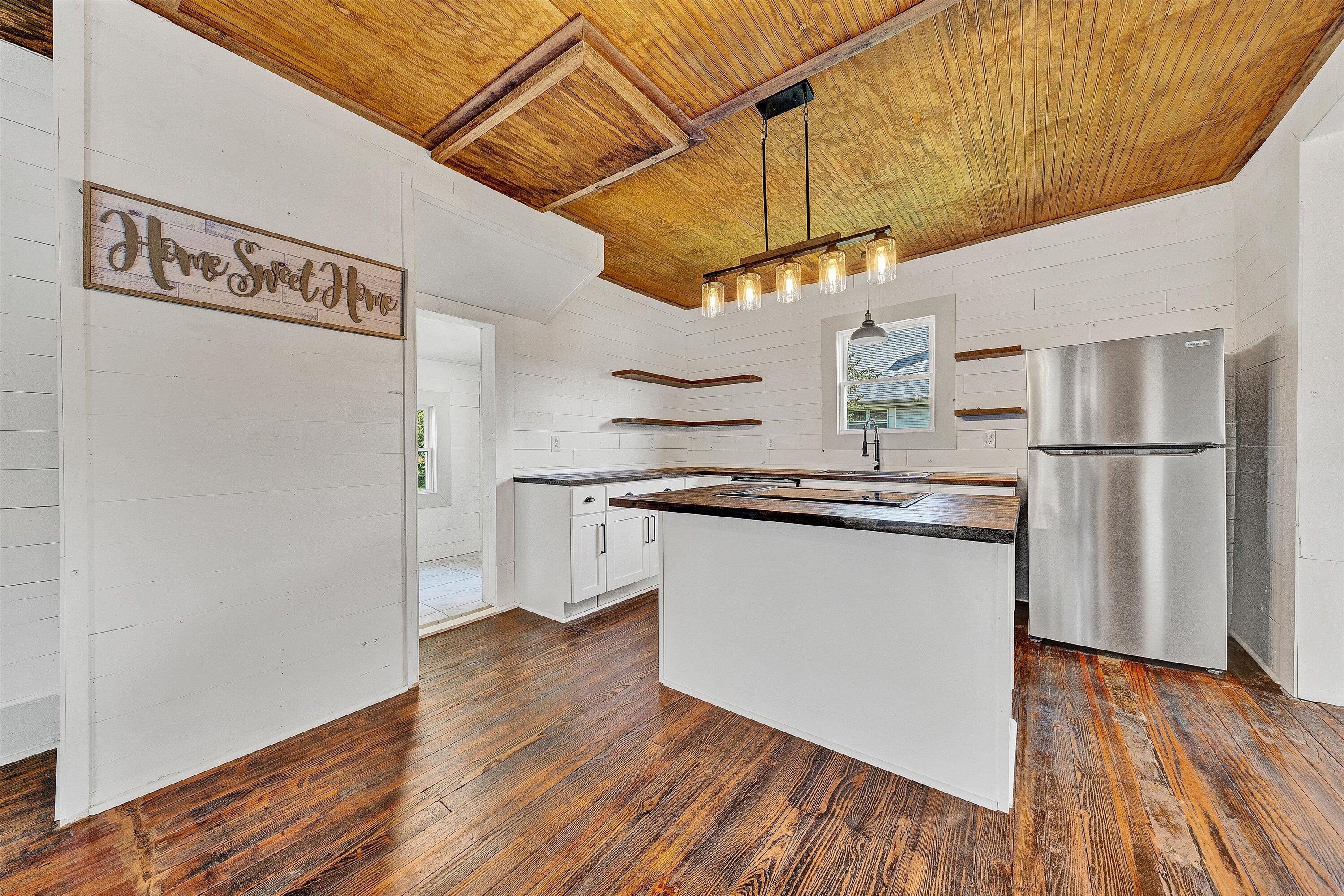 402 7th Street Salem, VA 24153 - Photo 6 of 32 a kitchen with stainless steel appliances granite countertop a refrigerator a stove and a wooden floor