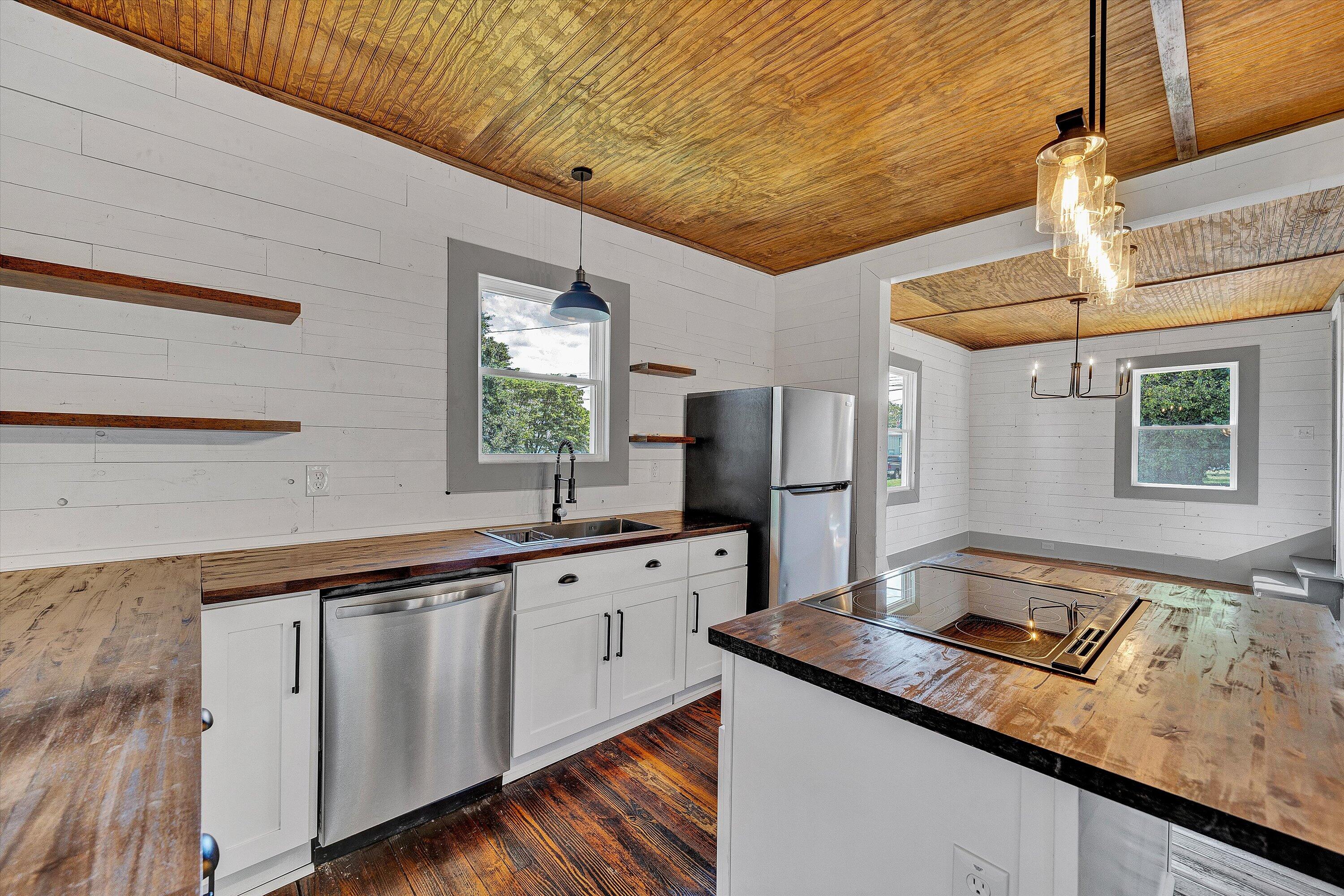 402 7th Street Salem, VA 24153 - Photo 7 of 32 a kitchen with granite countertop a sink stove and refrigerator