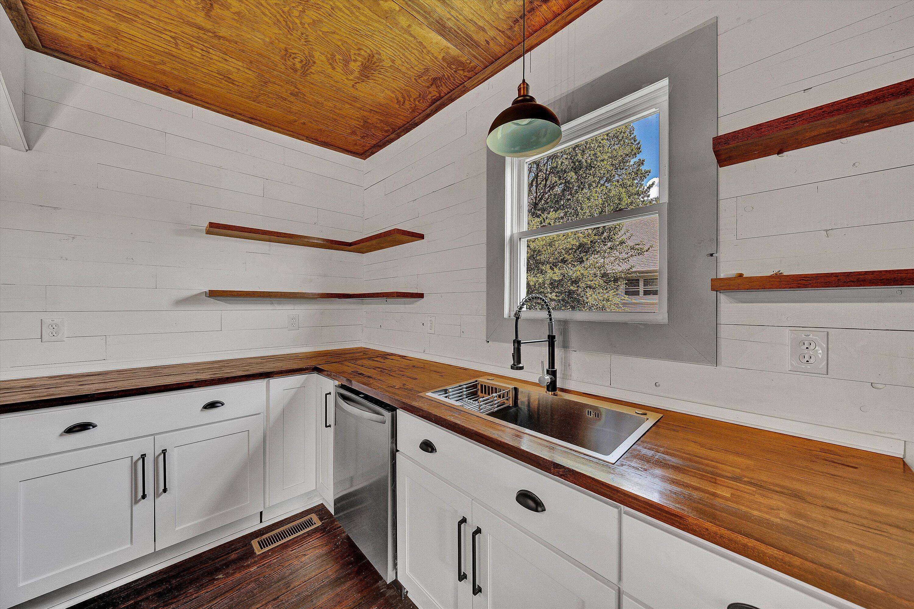 402 7th Street Salem, VA 24153 - Photo 9 of 32 a kitchen with granite countertop a sink a stove and cabinets