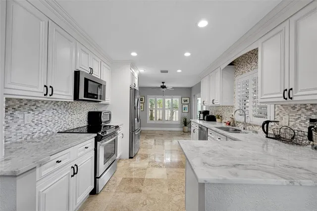 a kitchen with cabinets stainless steel appliances and a counter space