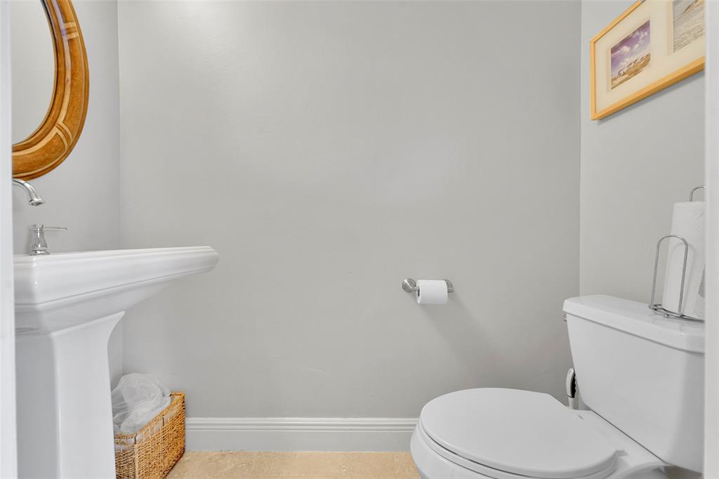 3588 Sahara Springs Boulevard Pompano Beach, FL 33069 - Photo 15 of 41 a white toilet sitting next to a bathroom sink