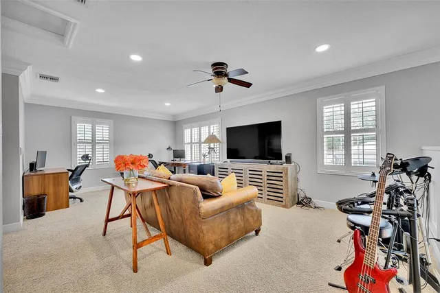 a bedroom with a bed and a ceiling fan in it