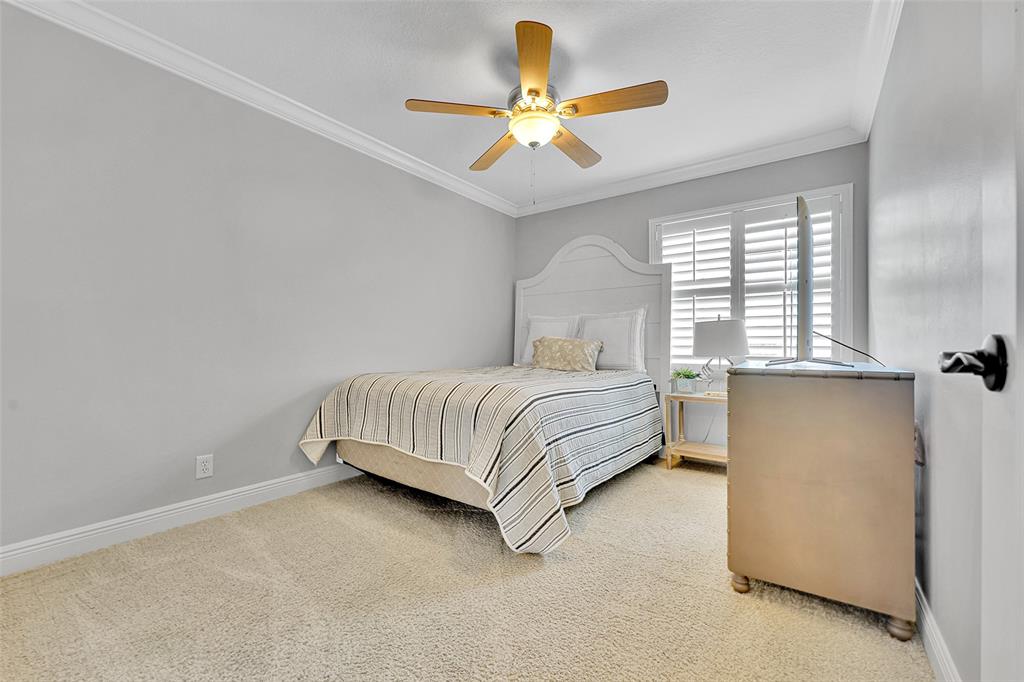 3588 Sahara Springs Boulevard Pompano Beach, FL 33069 - Photo 17 of 41 a bedroom with a bed and a ceiling fan in it