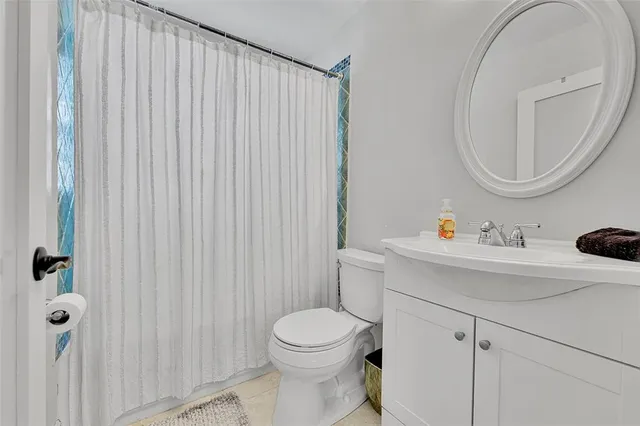 a spacious bedroom with a bed and a chandelier