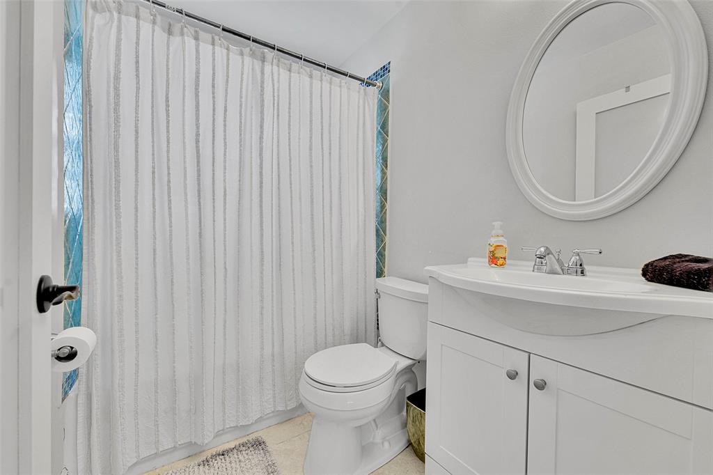 3588 Sahara Springs Boulevard Pompano Beach, FL 33069 - Photo 19 of 41 a bathroom with a sink a toilet and a mirror