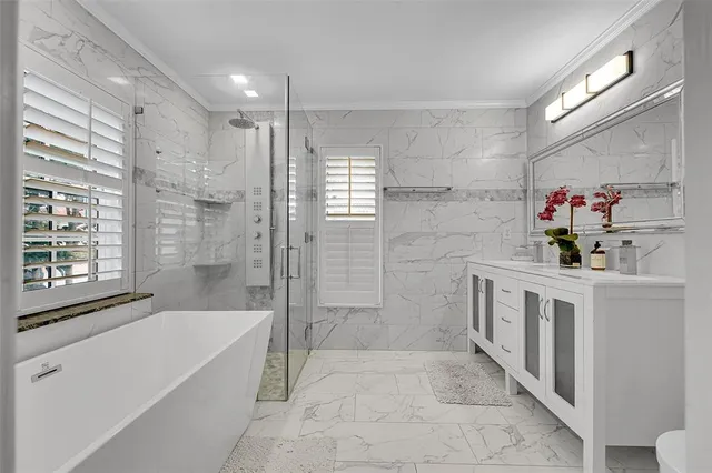 a bath tub sitting next to a shower