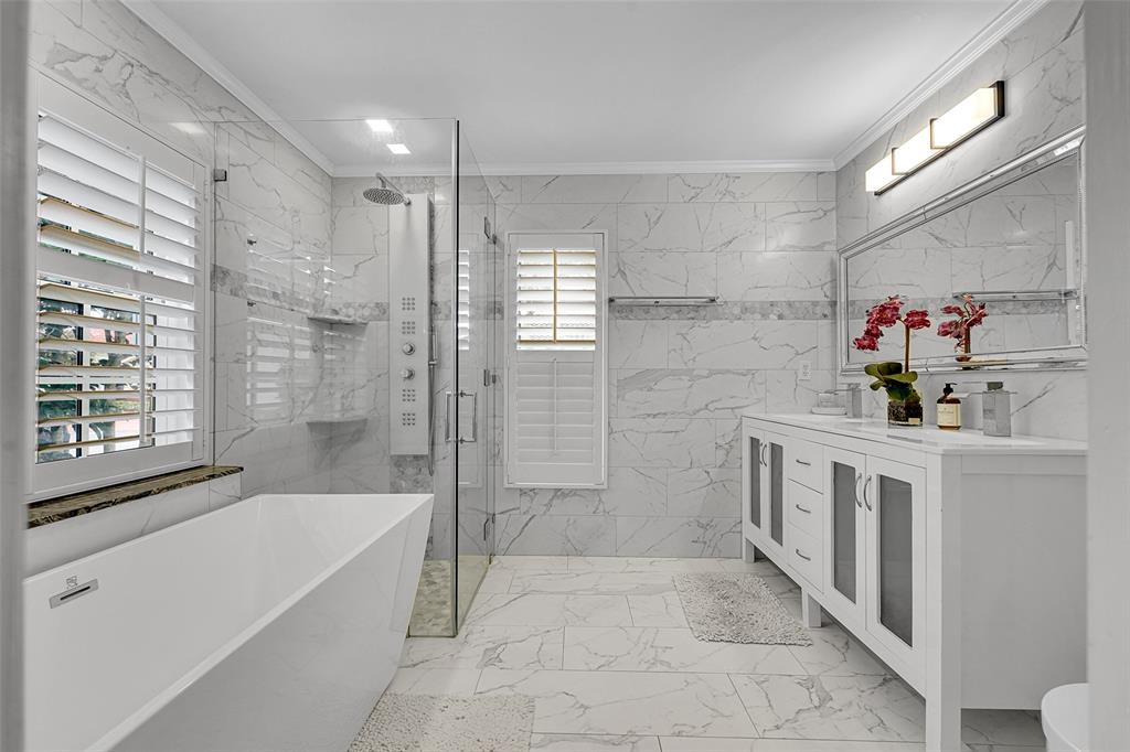 3588 Sahara Springs Boulevard Pompano Beach, FL 33069 - Photo 23 of 41 a bathroom with a tub sink and mirror