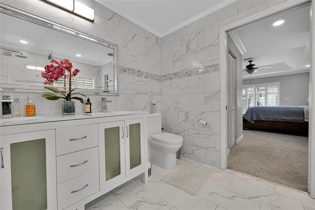 a dining room with wooden floor and a chandelier