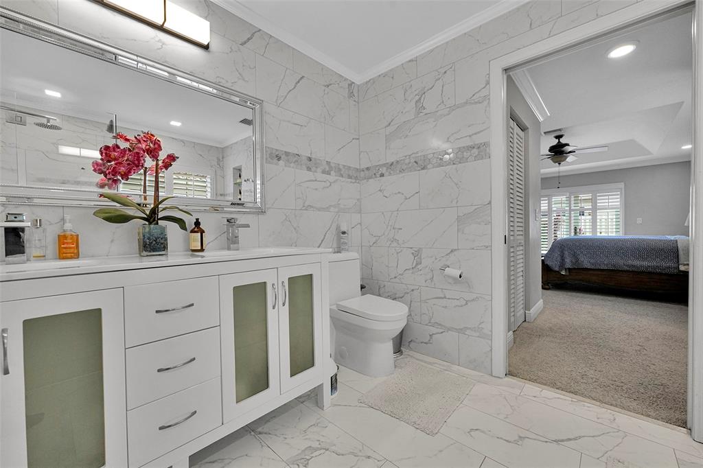 3588 Sahara Springs Boulevard Pompano Beach, FL 33069 - Photo 25 of 41 a bathroom with a sink a toilet and mirror