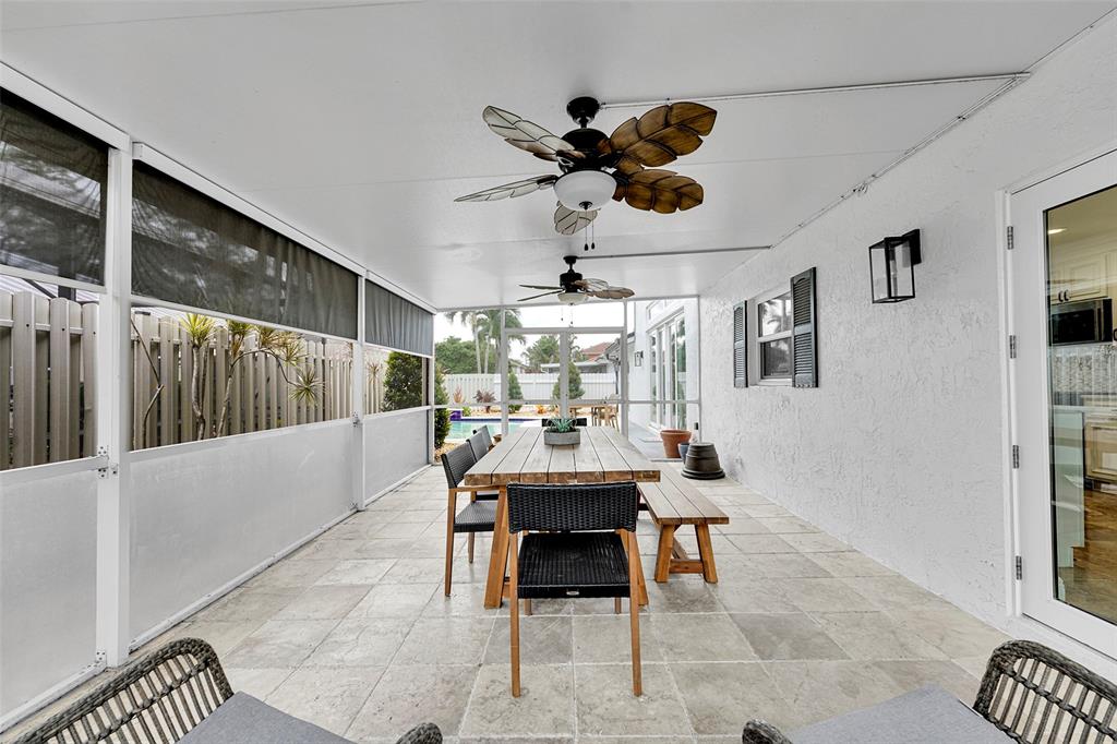 3588 Sahara Springs Boulevard Pompano Beach, FL 33069 - Photo 26 of 41 a dining room with wooden floor and a chandelier