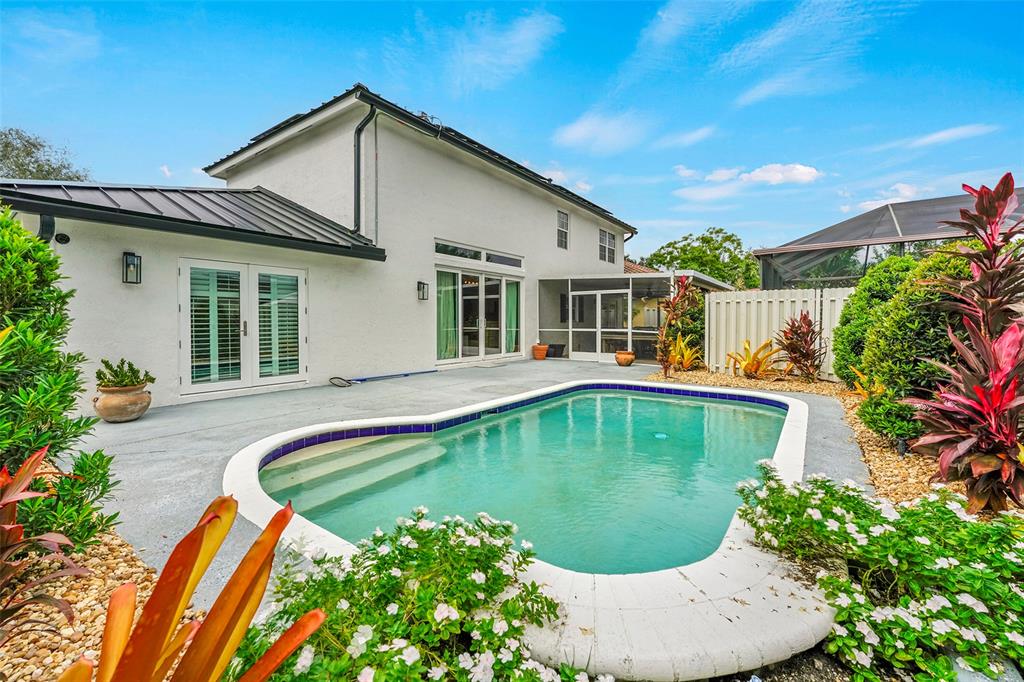 3588 Sahara Springs Boulevard Pompano Beach, FL 33069 - Photo 29 of 41 a swimming pool with outdoor seating and yard