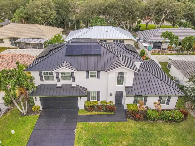 an aerial view of multiple houses with a yard