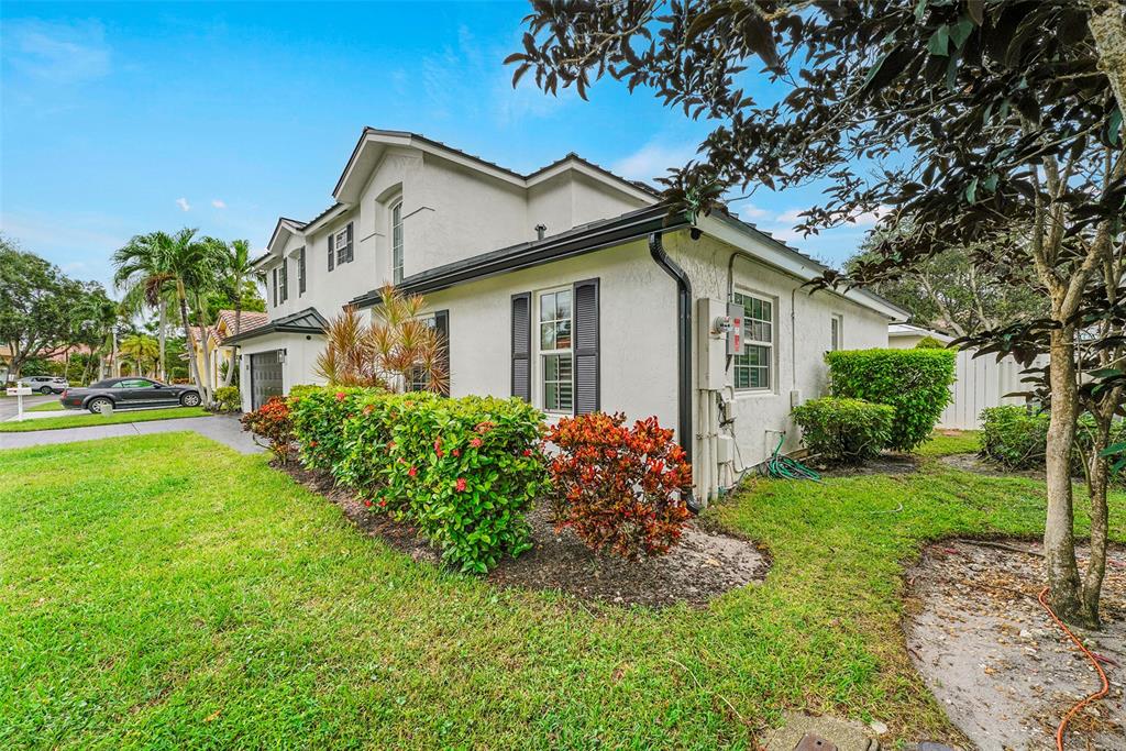 3588 Sahara Springs Boulevard Pompano Beach, FL 33069 - Photo 3 of 41 a front view of a house with garden