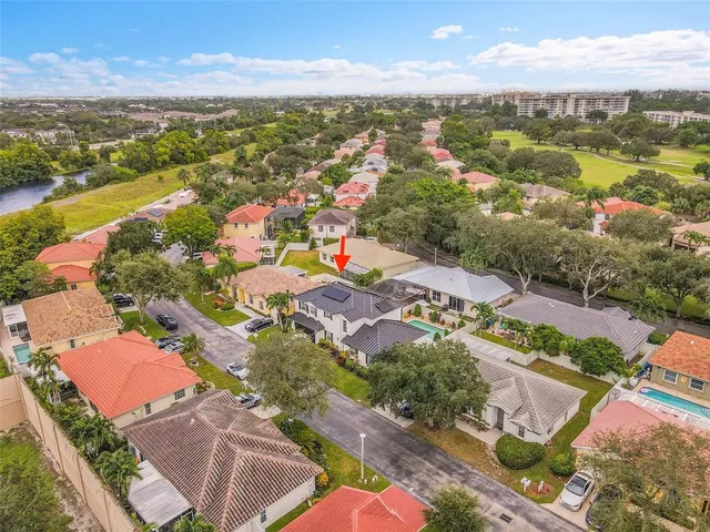 an aerial view of residential houses with outdoor space