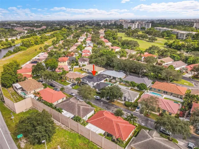 an aerial view of residential houses with outdoor space