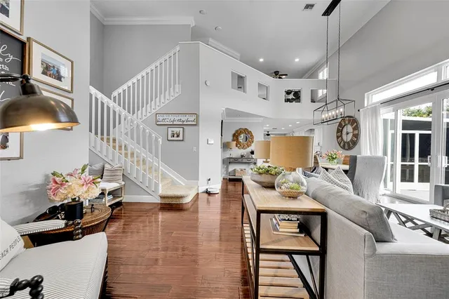 a living room with furniture a table and kitchen view