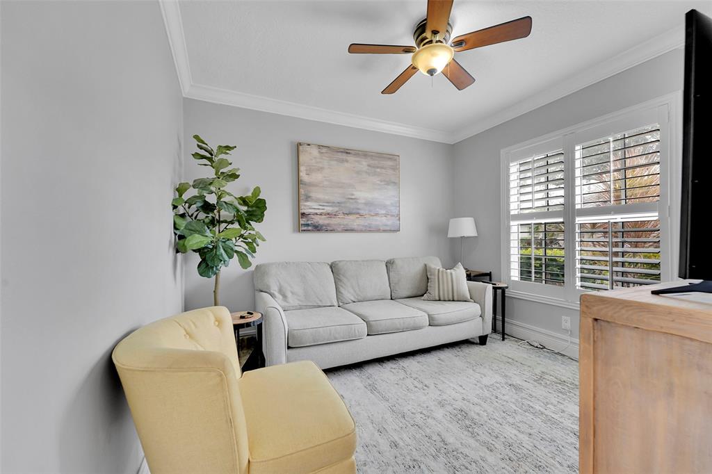 3588 Sahara Springs Boulevard Pompano Beach, FL 33069 - Photo 8 of 41 a living room with furniture and a large window