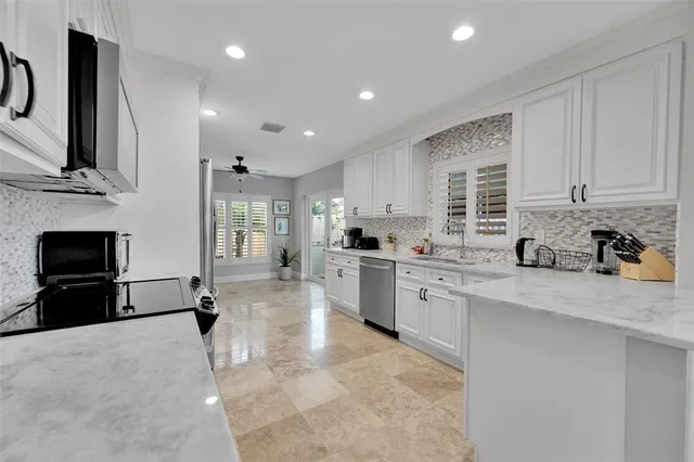 a view of a kitchen with furniture and a potted plant