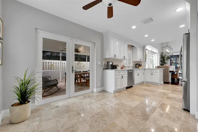 a kitchen with stainless steel appliances granite countertop a sink stove and cabinets