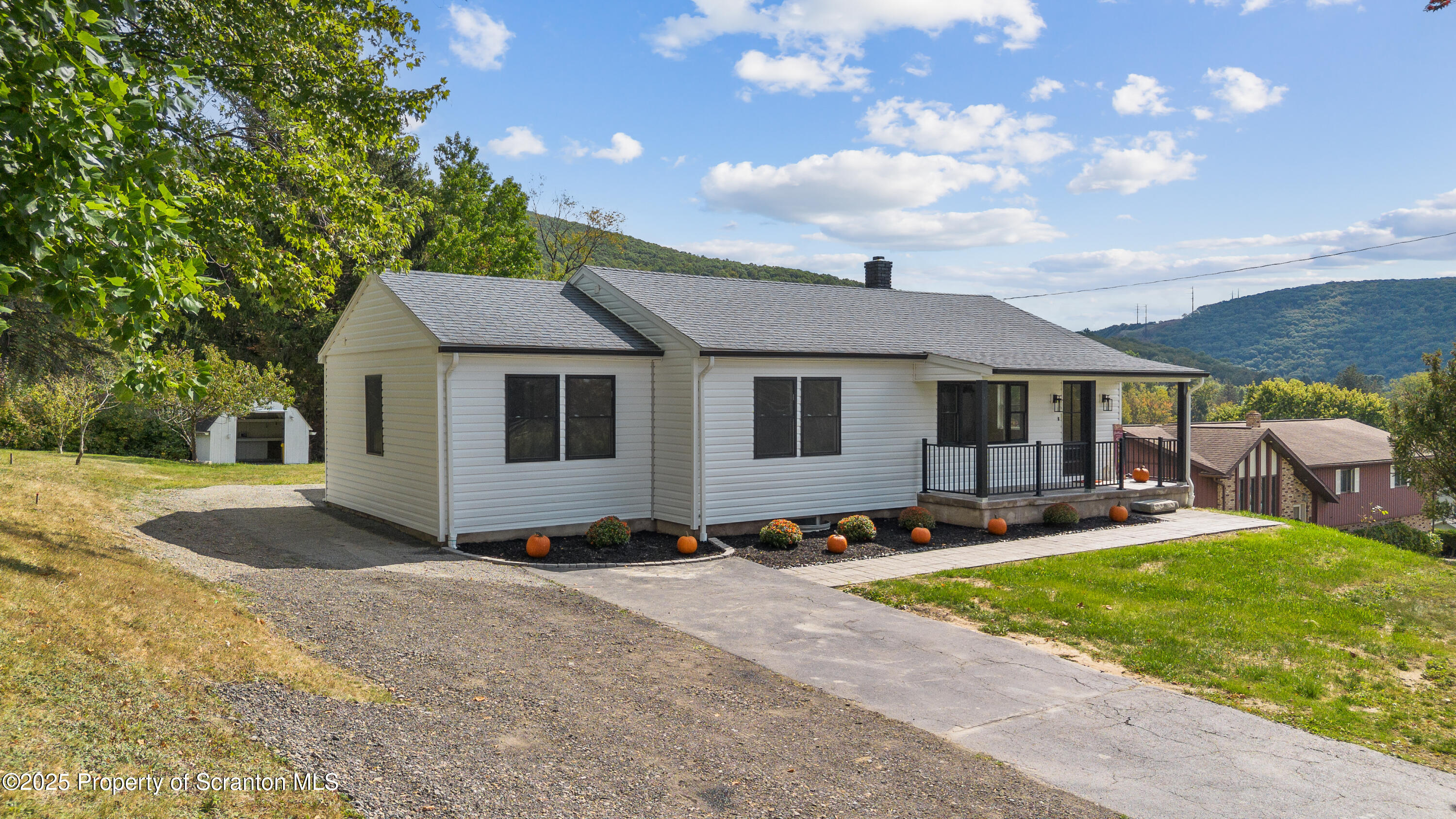 630 Layton Road Clarks Summit, PA 18411 - Photo 3 of 58 a front view of a house with a yard and trees