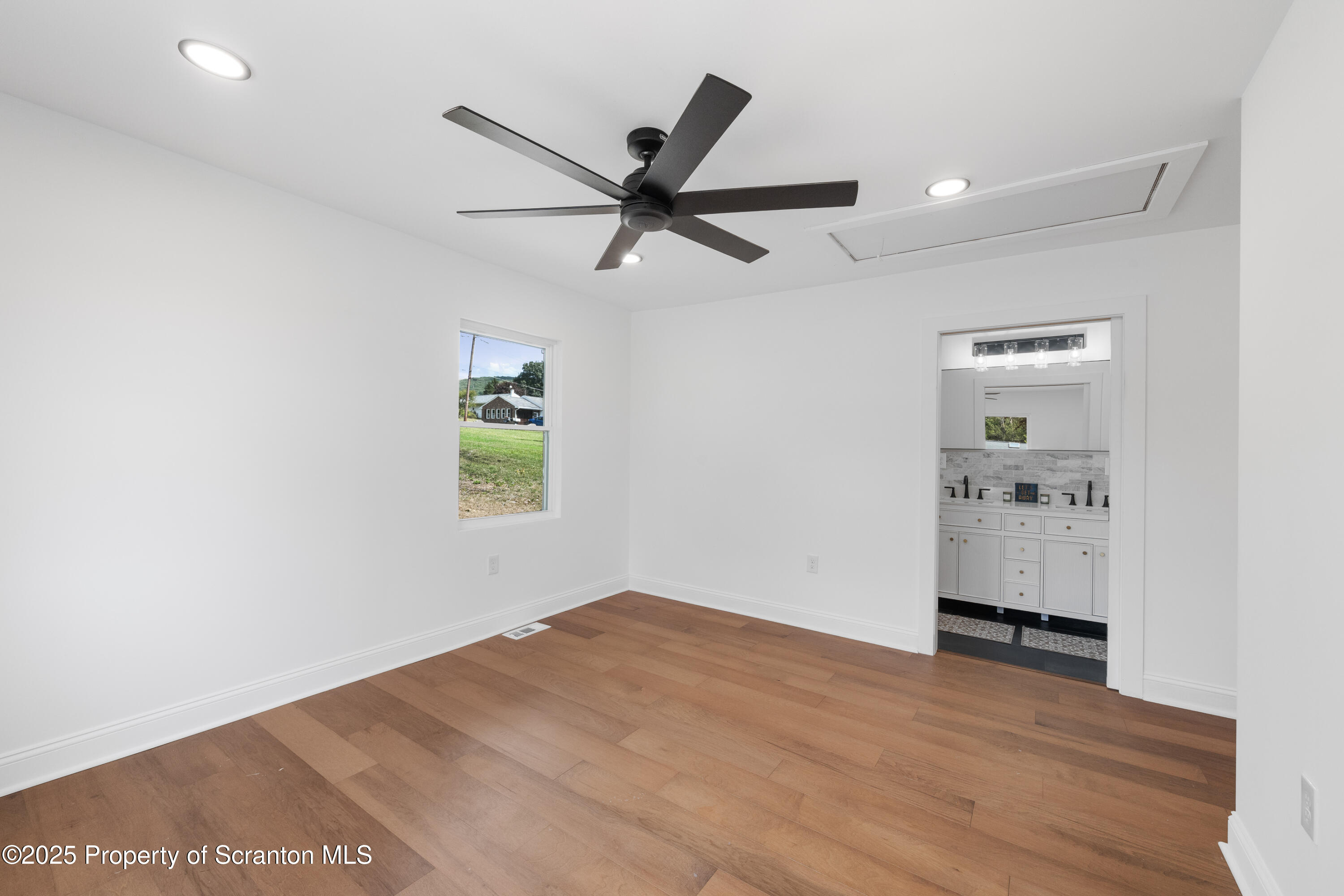 630 Layton Road Clarks Summit, PA 18411 - Photo 36 of 58 an empty room with windows and ceiling fan