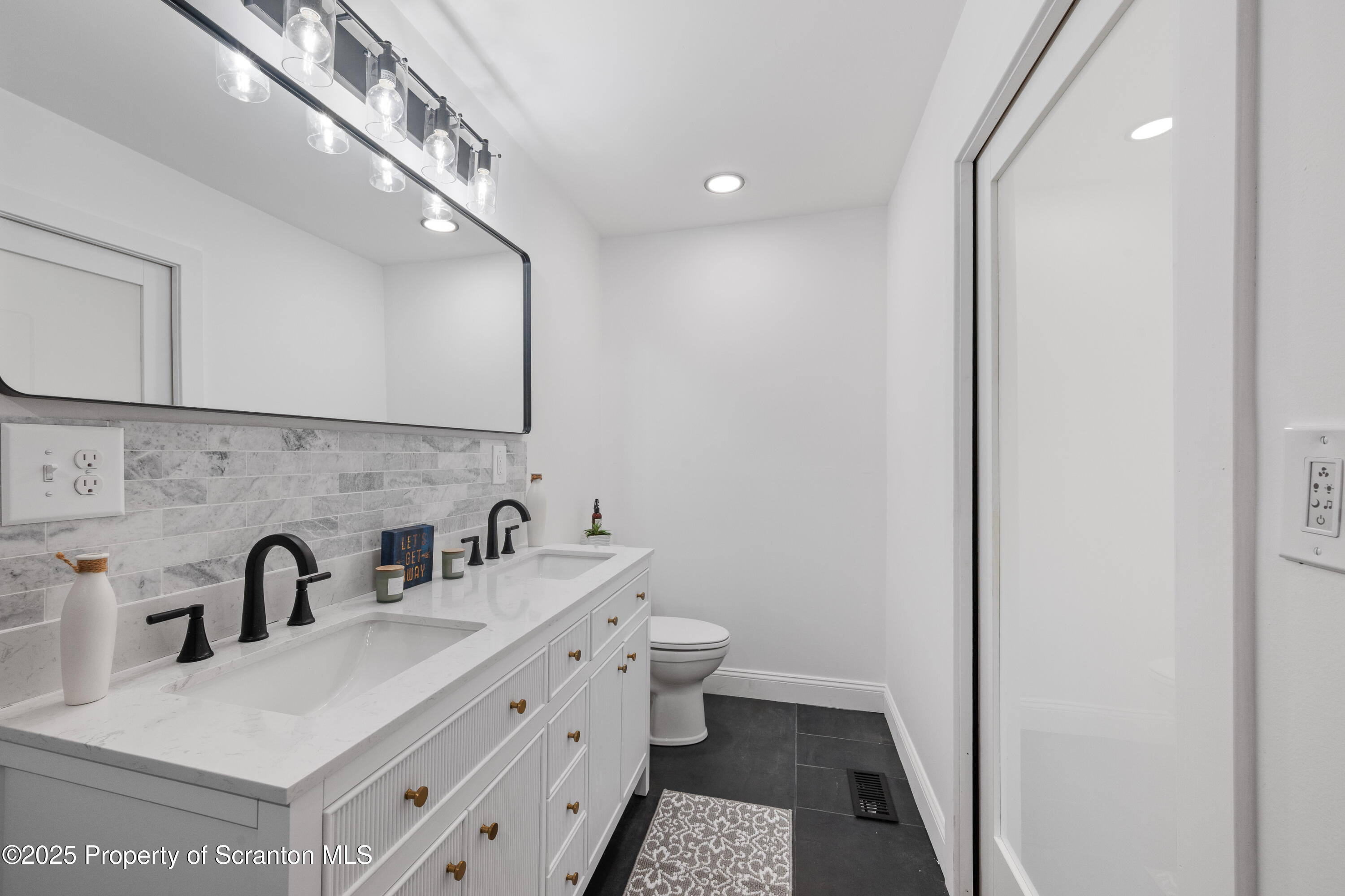 630 Layton Road Clarks Summit, PA 18411 - Photo 39 of 58 a bathroom with a sink and a mirror