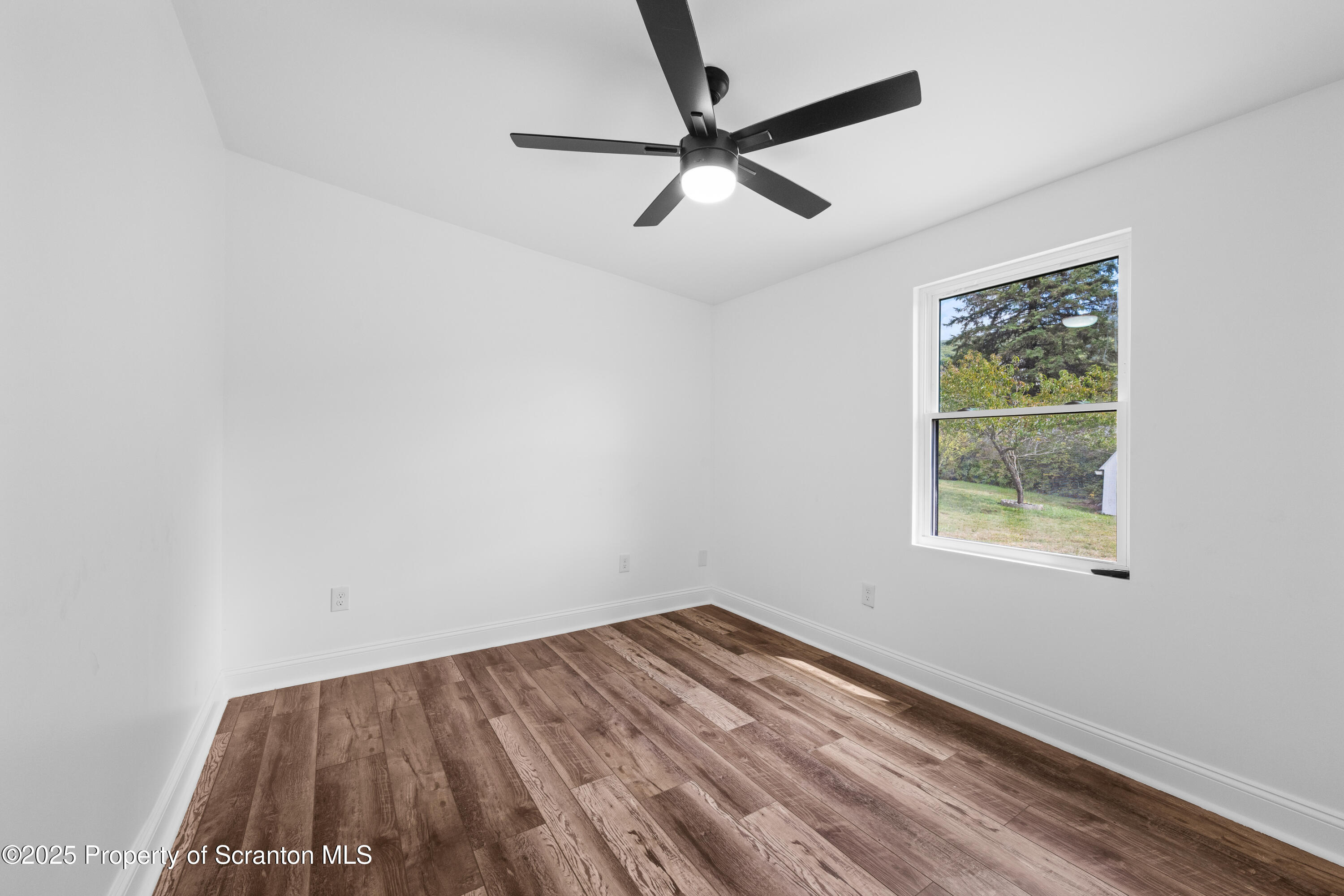 630 Layton Road Clarks Summit, PA 18411 - Photo 47 of 58 an empty room with a window and a ceiling fan