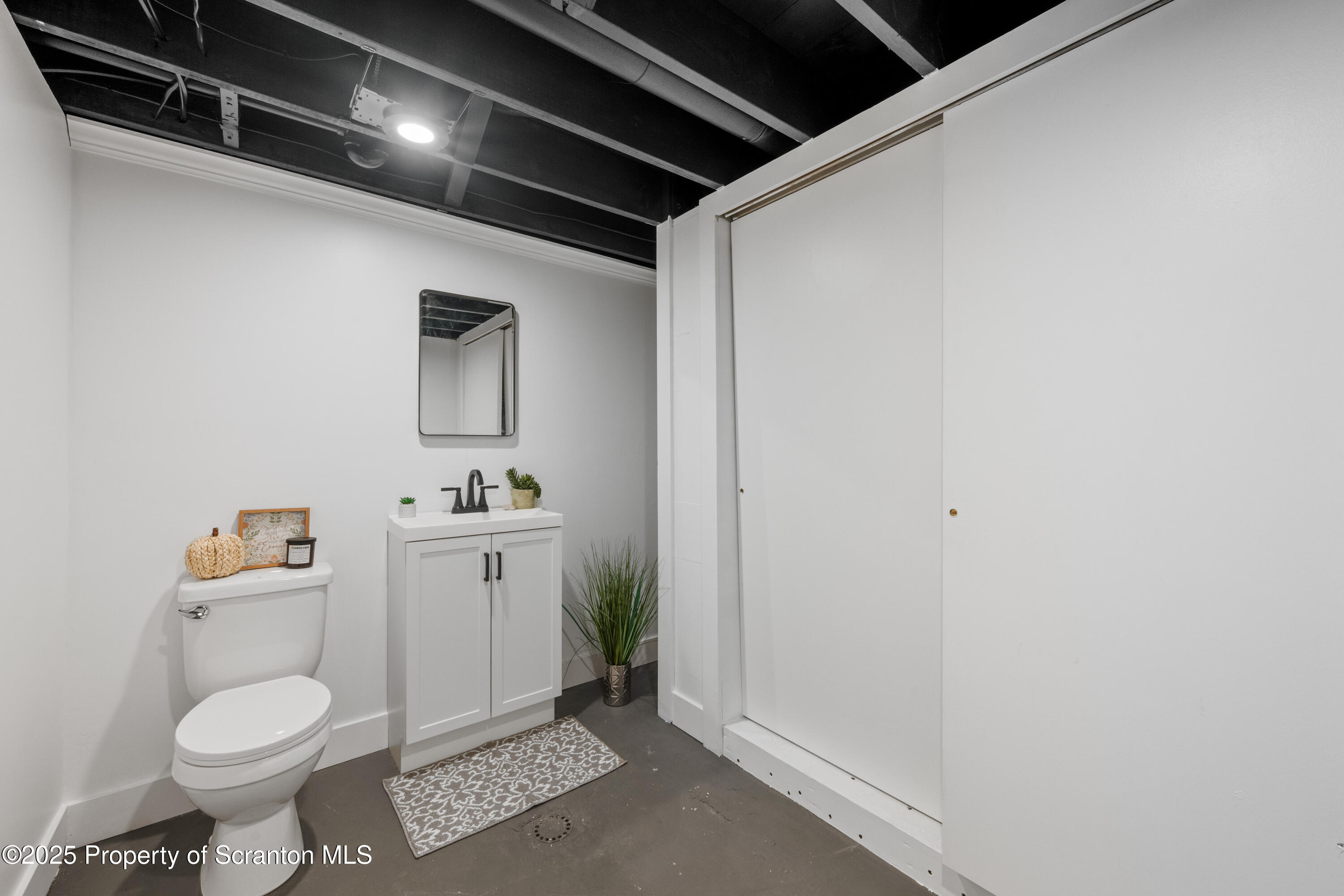 630 Layton Road Clarks Summit, PA 18411 - Photo 56 of 58 a bathroom with a toilet a sink and mirror