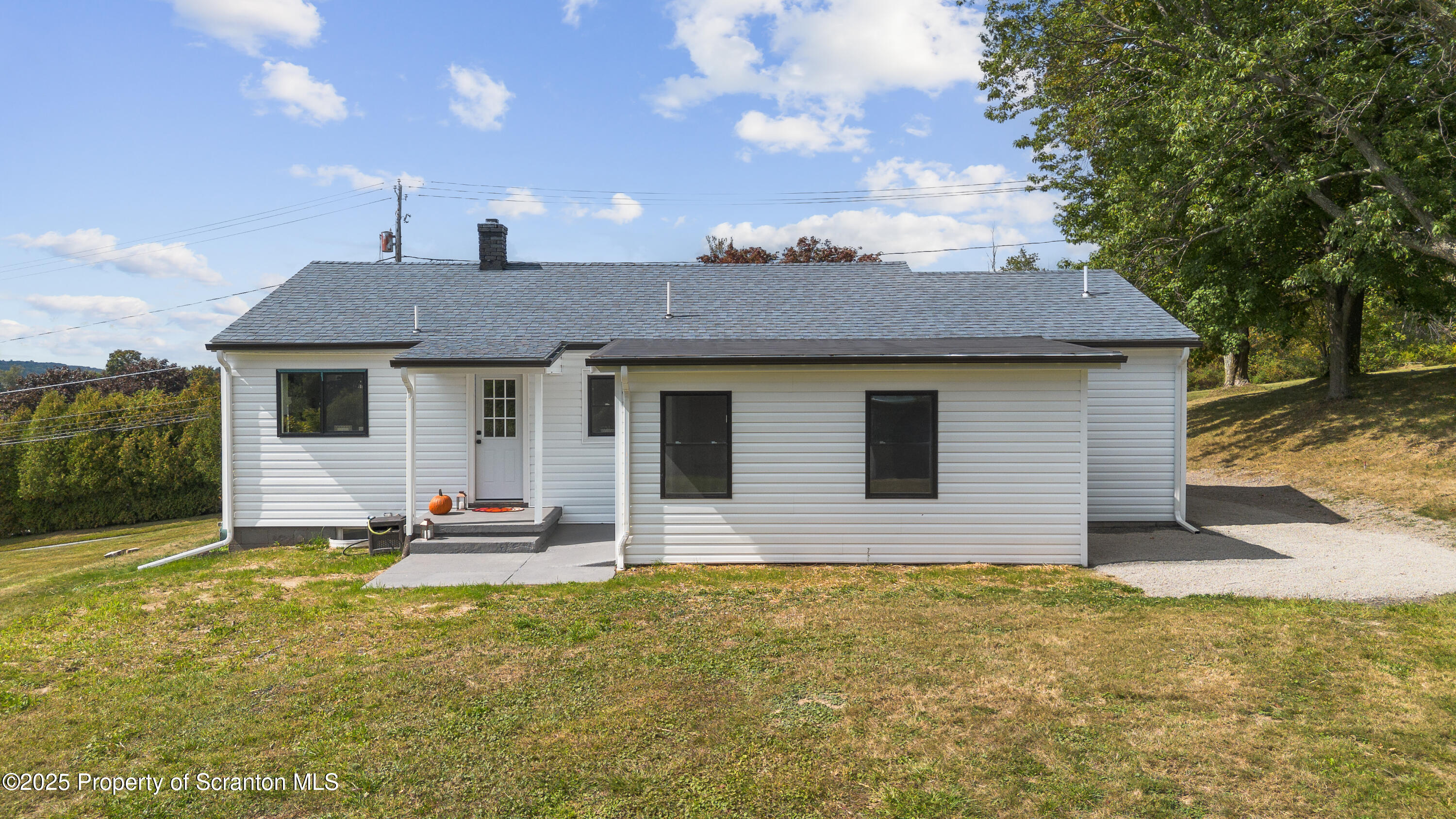 630 Layton Road Clarks Summit, PA 18411 - Photo 10 of 58 a front view of a house with a garden and yard
