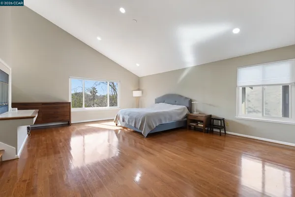 a spacious bedroom with a bed and a table in it