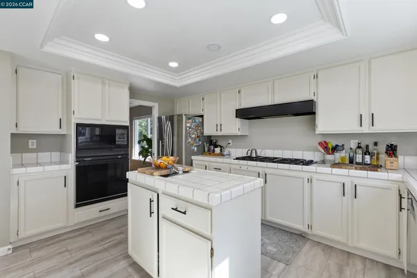 a kitchen with a stove a sink and a refrigerator