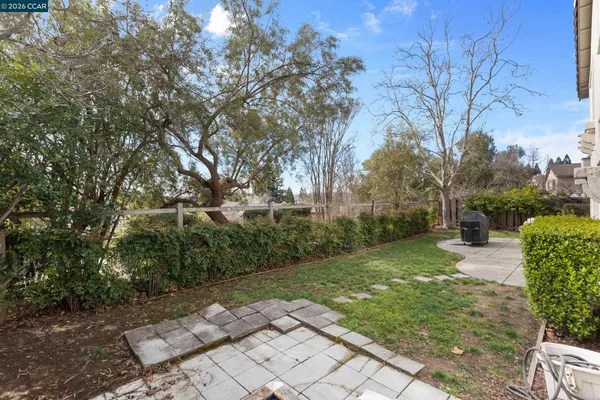 a backyard of a house with table and chairs