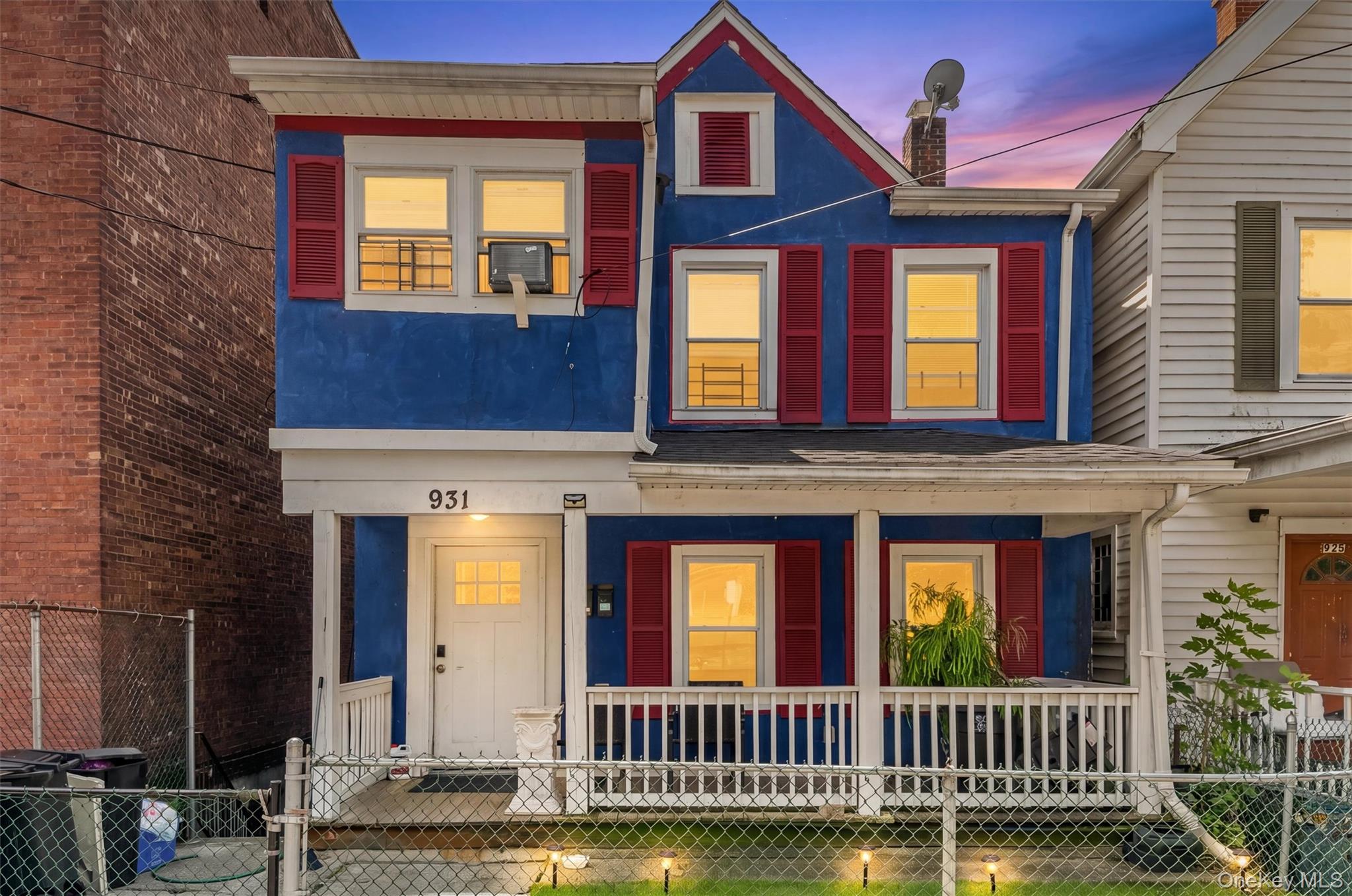 931 Diven Street Peekskill, NY 10566 - Photo 25 of 29 Vibrantly painted blue facade with contrasting red shutters