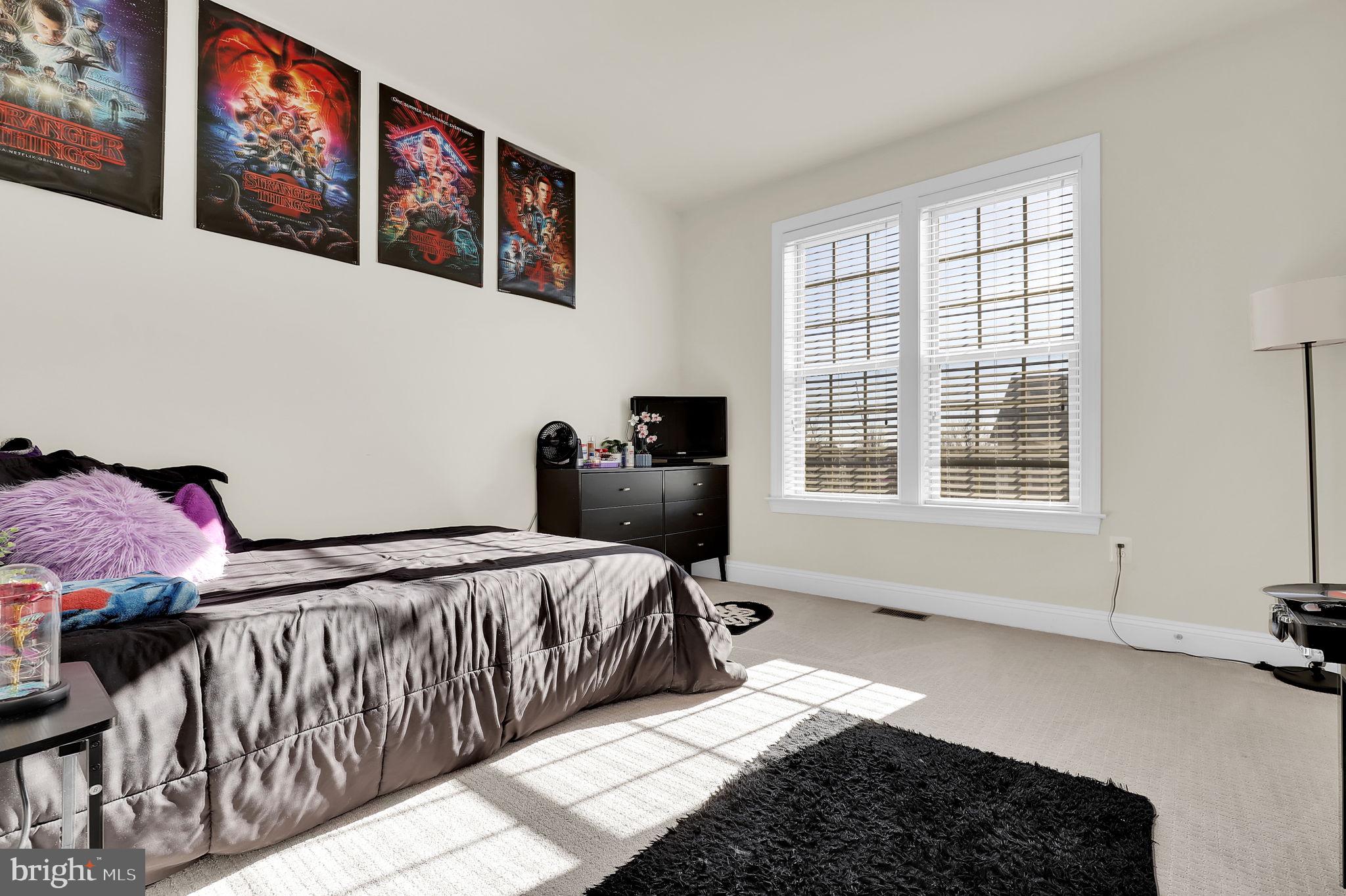 1305 Moore Spring Court Brunswick, MD 21716 - Photo 22 of 64 a bedroom with a bed and wooden floor
